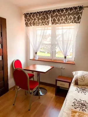 a room with a table and two chairs and a window at Dom u Kasi in Podwilk