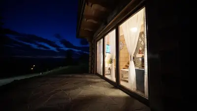 a building with a large window at night at Wioska Jasia i Małgosi in Izdebnik