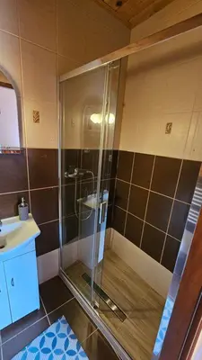 a shower in a bathroom with a sink at Agroturystyka na szlaku in Lubomierz