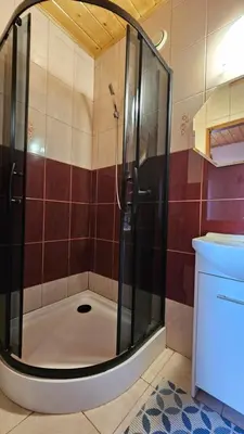 a shower with a glass door in a bathroom at Agroturystyka na szlaku in Lubomierz
