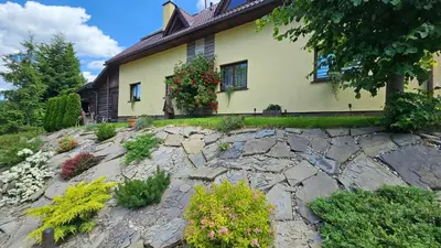 a house with a stone path in front of it at Agroturystyka na szlaku in Lubomierz