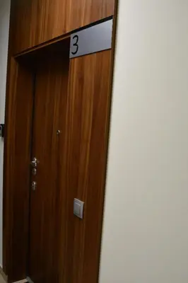 a wooden door with the number three on it at Cracovia Garden Nowa 5 Dzielnica in Kraków