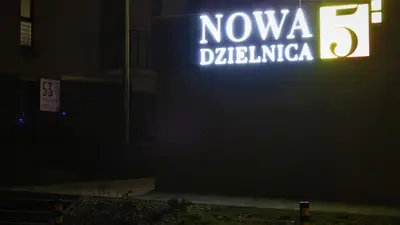 a neon sign that reads novaida dilliota on a building at Cracovia Garden Nowa 5 Dzielnica in Kraków