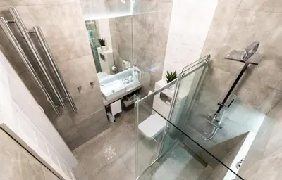 a bathroom with a sink and a glass shower at Crystal Luxury Apartments Rakowicka 20H in Kraków