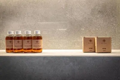 three bottles of honey on a shelf next to a box at Crystal Luxury Apartments Rakowicka 20H in Kraków