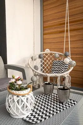 a porch with a swing and a table at Crystal Luxury Apartments Rakowicka 20H in Kraków