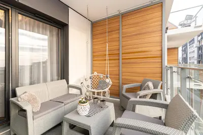 a balcony with chairs and a table at Crystal Luxury Apartments Rakowicka 20H in Kraków