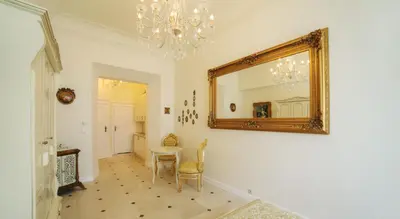a dining room with a mirror and a table at Only Kraków Apartments in Kraków