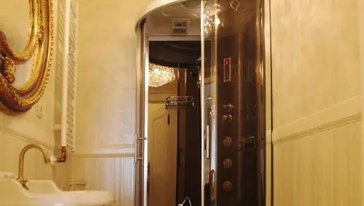 a bathroom with a shower and a sink and a mirror at Only Kraków Apartments in Kraków