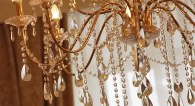 a gold chandelier hanging from a ceiling at Only Kraków Apartments in Kraków