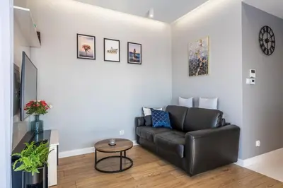 a living room with a couch and a table at atHome Suites in Kraków
