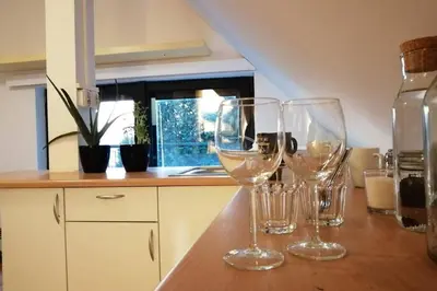 three wine glasses sitting on a counter in a kitchen at Koci Dom in Wieliczka