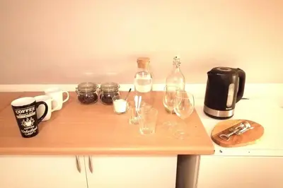 a table with wine glasses and bottles on it at Koci Dom in Wieliczka
