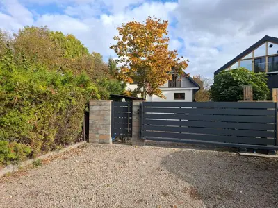 a black fence in front of a house at Koci Dom in Wieliczka