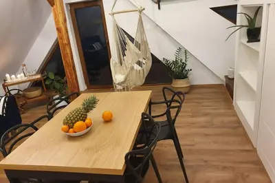 a wooden table with a bowl of fruit on it at Koci Dom Loft in Wieliczka