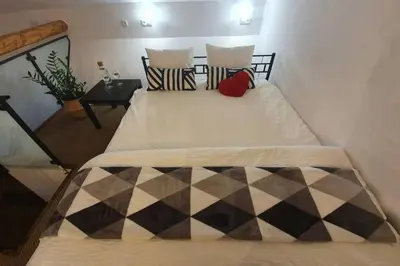 a bedroom with two beds with pillows on it at Koci Dom Loft in Wieliczka
