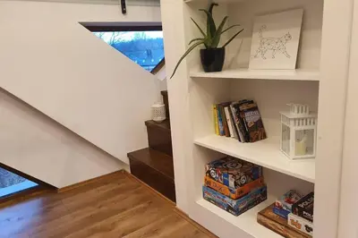 a staircase with white shelves in a house at Koci Dom Loft in Wieliczka