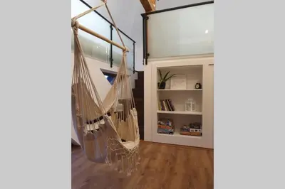 a room with a hammock hanging from a wall at Koci Dom Loft in Wieliczka