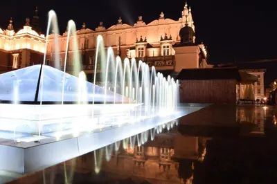 a group of water fountains in front of a building at Last Floor Apartment - Krakow City Center close to Old Town in Kraków