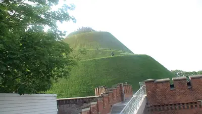 a large green hill with stairs in front of a building at Last Floor Apartment - Krakow City Center close to Old Town in Kraków