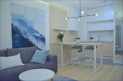 a living room with a couch and a kitchen at Last Floor Apartment - Krakow City Center close to Old Town in Kraków