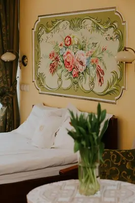 a bedroom with a bed with a painting on the wall at Aparthotel Grodzka 21 Self-Check in in Kraków