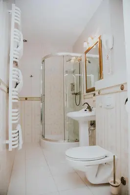 a bathroom with a toilet and a sink and a shower at Aparthotel Grodzka 21 Self-Check in in Kraków