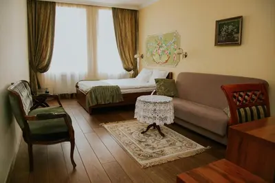 a living room with a couch and a bed at Aparthotel Grodzka 21 Self-Check in in Kraków