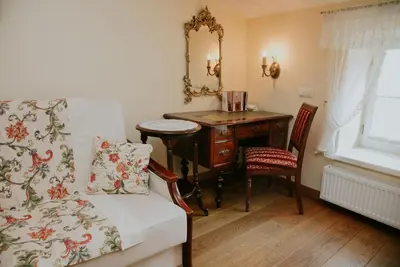 a bedroom with a desk and a bed and a mirror at Aparthotel Grodzka 21 Self-Check in in Kraków