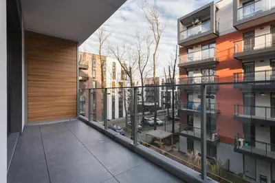 an apartment balcony with a view of a city at City of the Kings - Leaf Apartment in Kraków