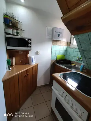 a small kitchen with a sink and a microwave at Apartament-studio, pokoje u Lucy in Rabka