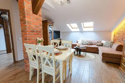 a living room with a couch and a table at Bronowicka Premium Apartment - 52m2 with private parking in Kraków