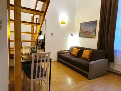 a living room with a couch and a table at Safona - Pantheon Apartments in Kraków
