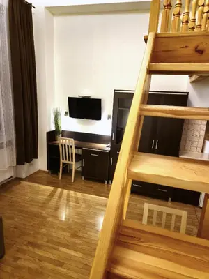 a living room with a desk and a ladder at Safona - Pantheon Apartments in Kraków