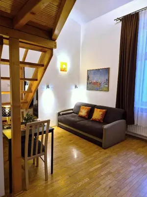 a living room with a couch and a table at Safona - Pantheon Apartments in Kraków