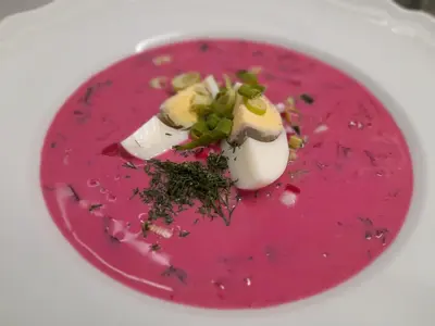 a plate of food with pink sauce and herbs at Merci Boutique Hotel in Kraków