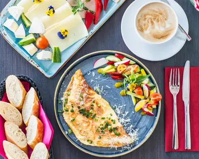 a table topped with a plate of food with a piece of fish at Merci Boutique Hotel in Kraków