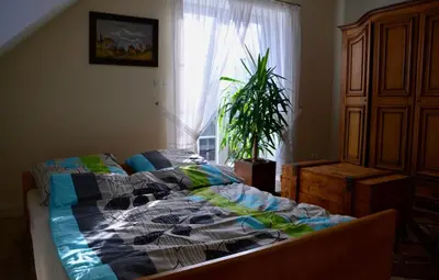 a bedroom with a bed with a quilt on it at Siedlisko Inwałd in Inwałd