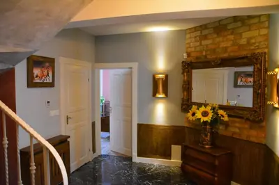 a hallway with a mirror and a vase of flowers at Siedlisko Inwałd in Inwałd