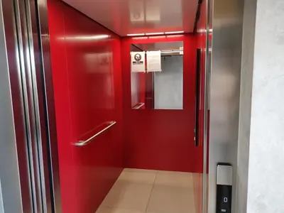 a red elevator with a red door in a building at Apartament Kraków Arena No 76 in Kraków
