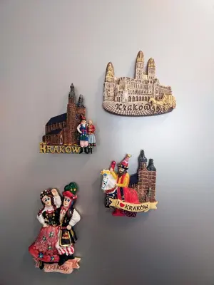 a group of figurines hanging on a wall at Piast Apartament in Kraków