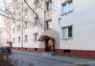 a building with a door on the side of a street at Piast Apartament in Kraków
