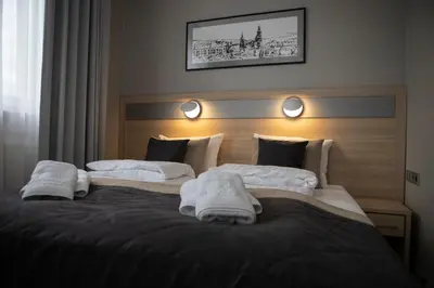 a bedroom with two beds with towels on them at Krowodrza Centrum Konferencyjno - Hotelowe in Kraków