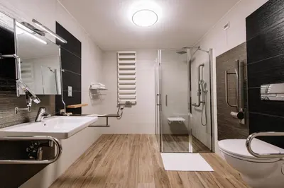 a bathroom with a shower and a sink and a toilet at Krowodrza Centrum Konferencyjno - Hotelowe in Kraków