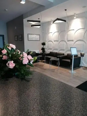 a lobby with couches and flowers in a room at Krowodrza Centrum Konferencyjno - Hotelowe in Kraków