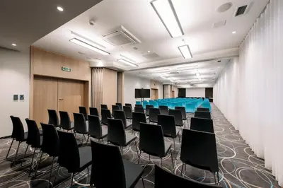 a conference room with black chairs and a table at Krowodrza Centrum Konferencyjno - Hotelowe in Kraków