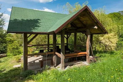 a gazebo with a green roof in a field at Amigówka in Wieliczka