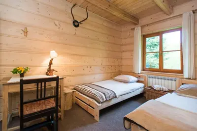 a bedroom with two beds in a log cabin at Amigówka in Wieliczka