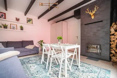 a living room with a table and a fireplace at Zawoja 1725 - Slow Life Cabins in Zawoja
