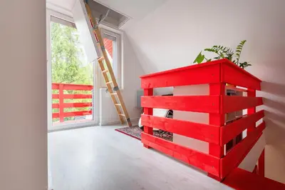 a red chest of drawers in a room with a window at Zawoja 1725 - Slow Life Cabins in Zawoja